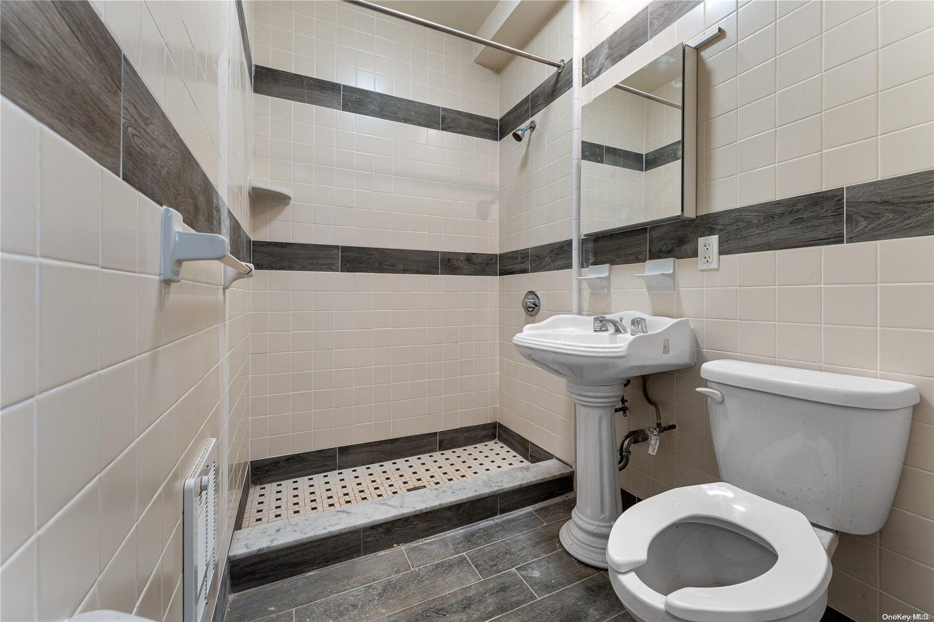 5112 Post Road Bronx, NY 10471 - Photo 29 of 35 a bathroom with a sink toilet and a mirror
