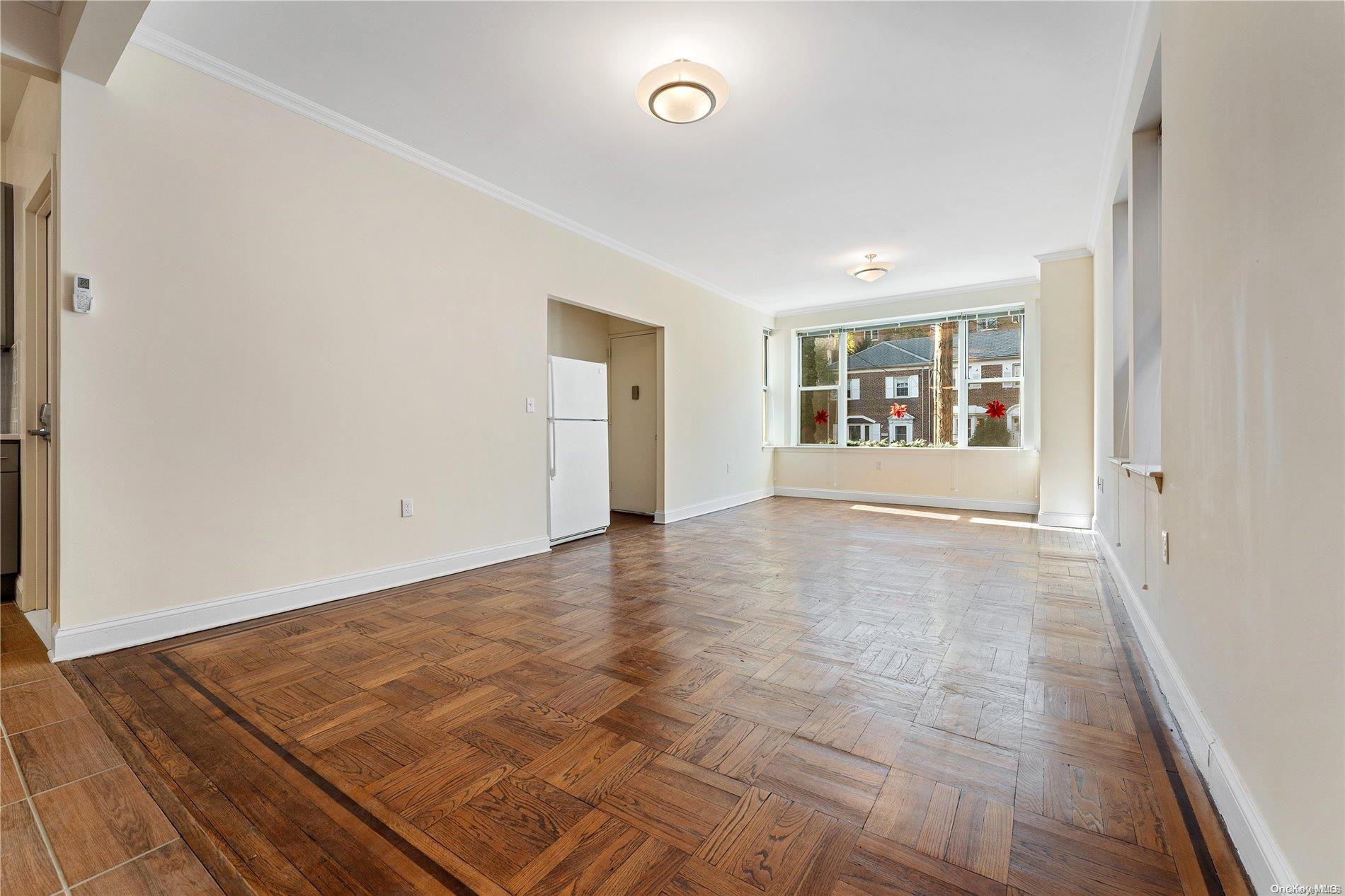 5112 Post Road Bronx, NY 10471 - Photo 6 of 35 a view of an empty room with wooden floor and a window