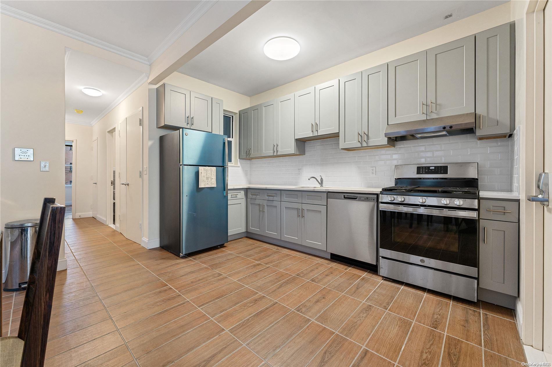 5112 Post Road Bronx, NY 10471 - Photo 9 of 35 a kitchen with stainless steel appliances a refrigerator sink and cabinets