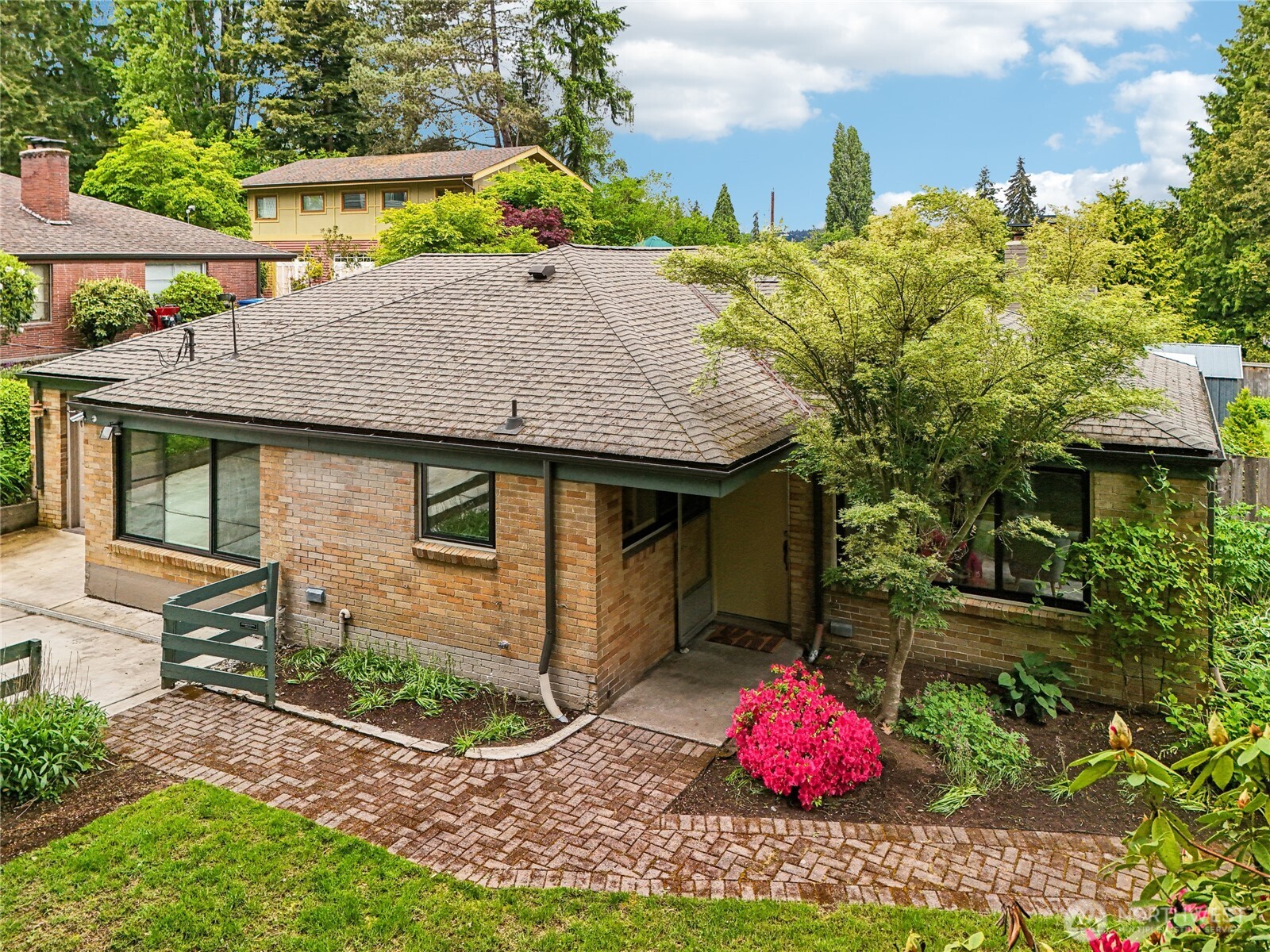 a backyard of a house with table and chairs