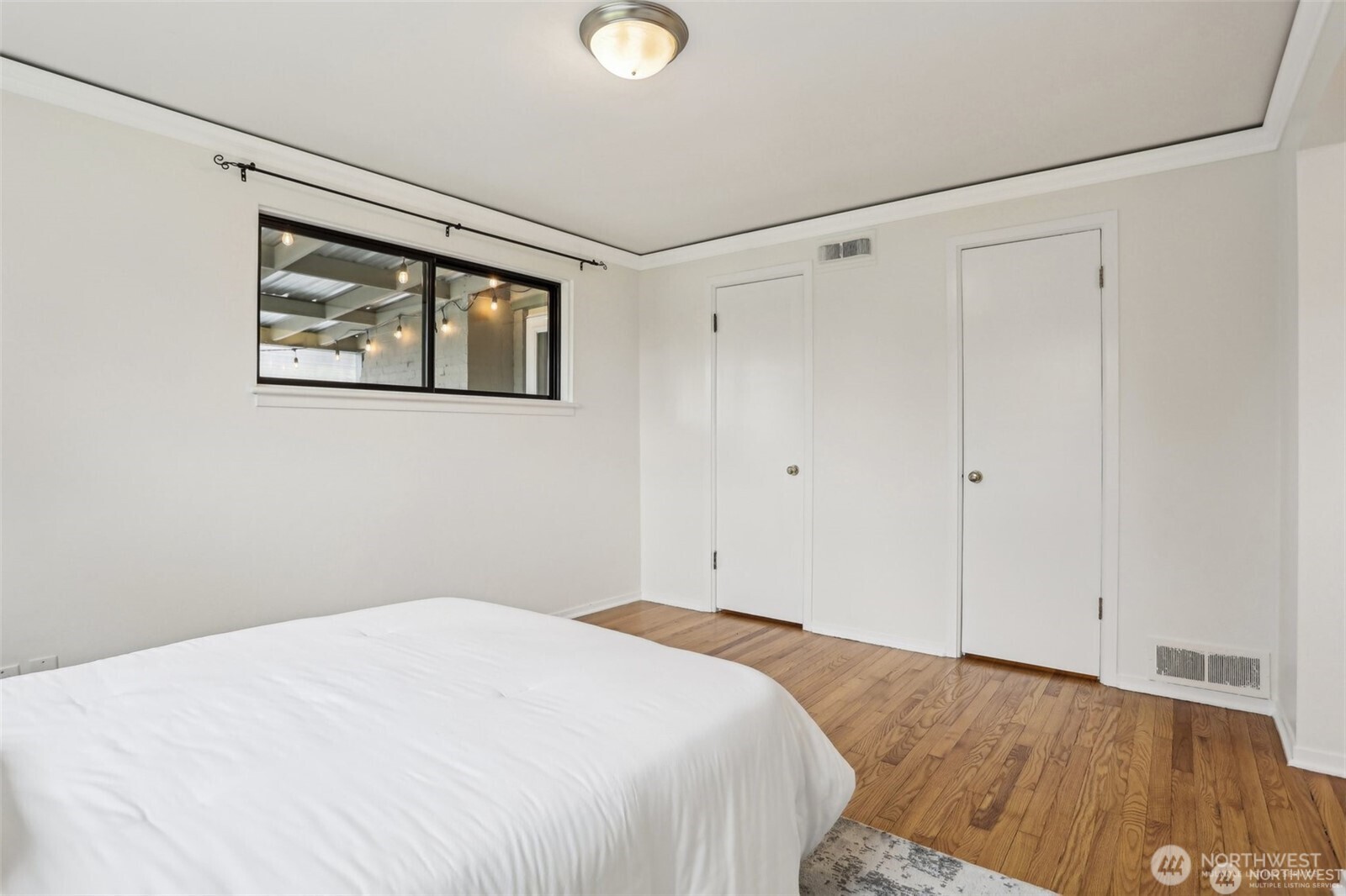 3532 Northeast 97th Street Seattle, WA 98115 - Photo 13 of 27 a bedroom with a bed and a window
