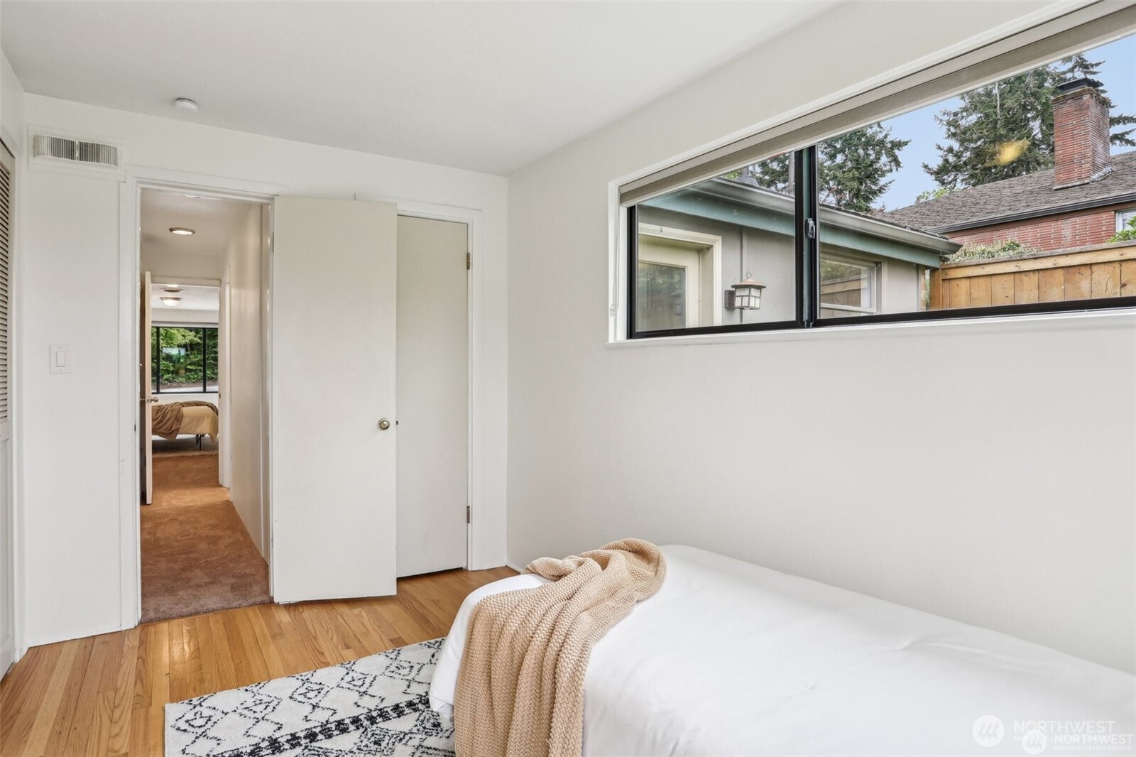 3532 Northeast 97th Street Seattle, WA 98115 - Photo 16 of 27 a bedroom with a bed and wooden floor