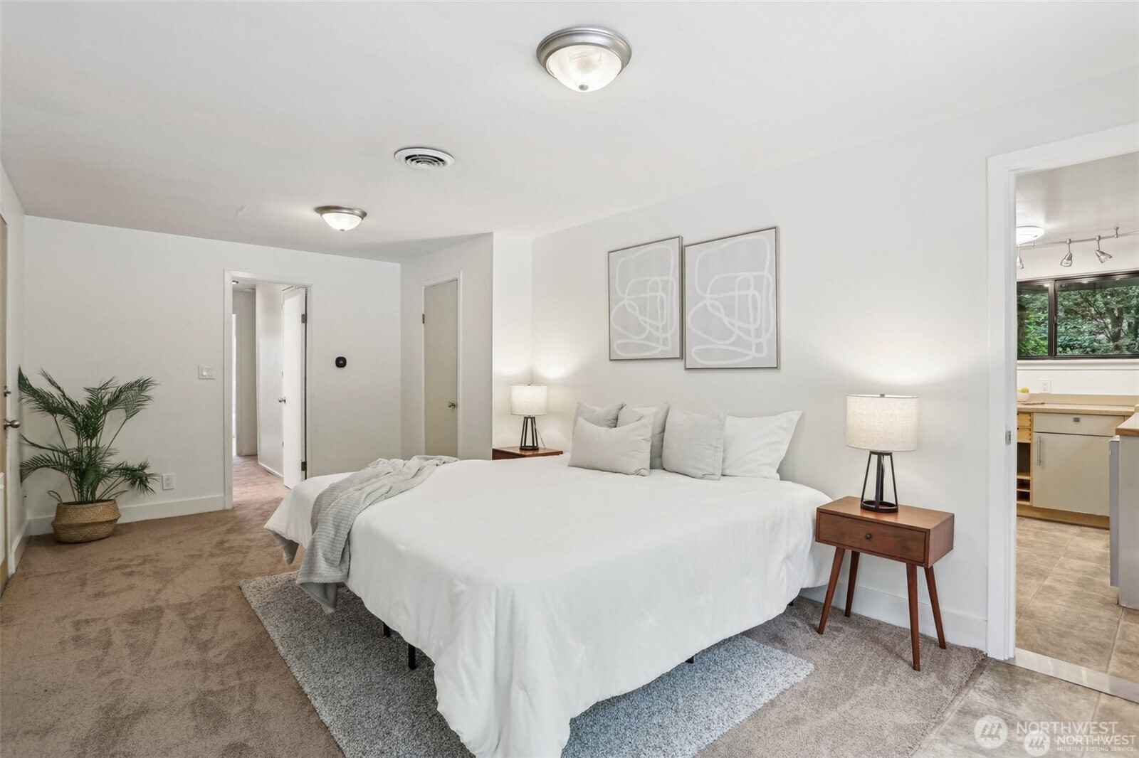 3532 Northeast 97th Street Seattle, WA 98115 - Photo 19 of 27 a bedroom with a bed and a potted plant