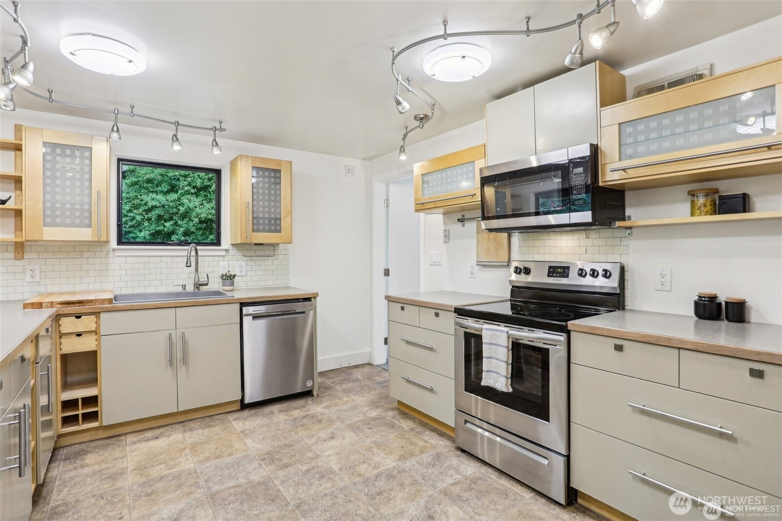 3532 Northeast 97th Street Seattle, WA 98115 - Photo 8 of 27 a kitchen with stainless steel appliances granite countertop a sink and a stove