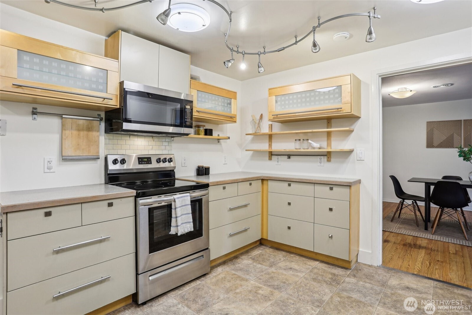 3532 Northeast 97th Street Seattle, WA 98115 - Photo 10 of 27 a kitchen with stainless steel appliances granite countertop a stove sink and cabinets