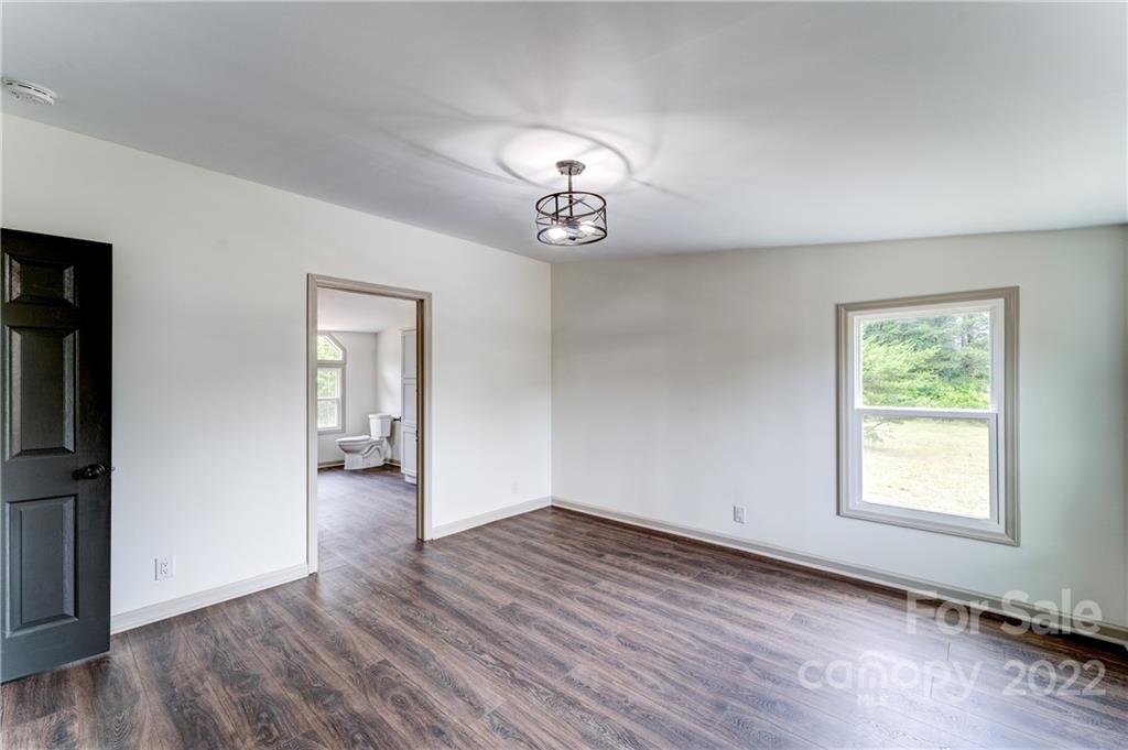 1569 Lawrence Road Clover, SC 29710 - Photo 15 of 26 an empty room with wooden floor cabinet and windows