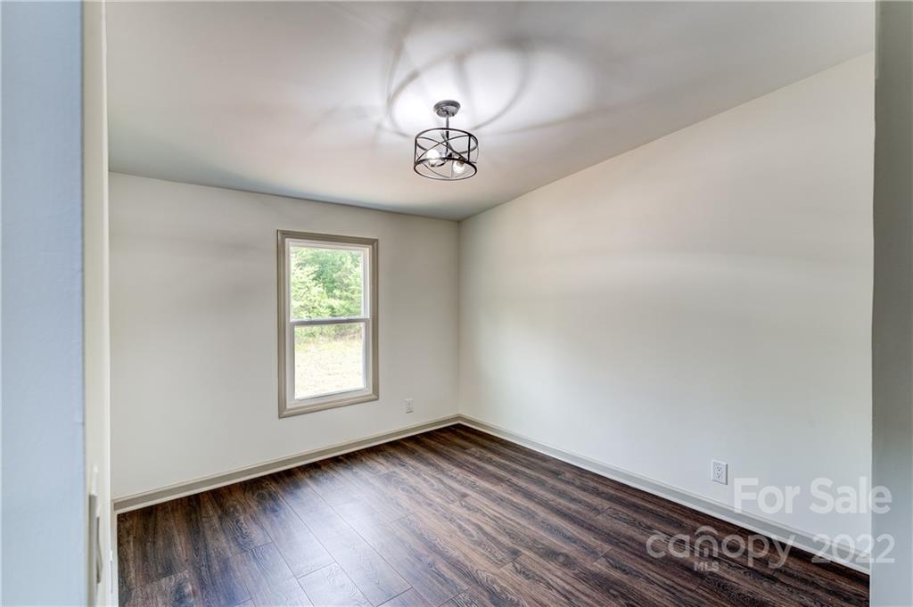 1569 Lawrence Road Clover, SC 29710 - Photo 18 of 26 an empty room with wooden floor and window