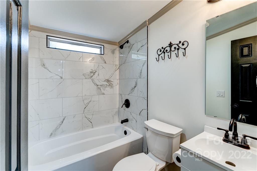 1569 Lawrence Road Clover, SC 29710 - Photo 20 of 26 a bathroom with a bathtub and a toilet