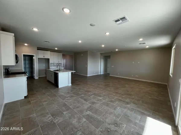 a view of kitchen with stainless steel appliances a refrigerator and a stove top oven