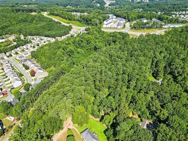 a backyard of a house with lots of green space and trees