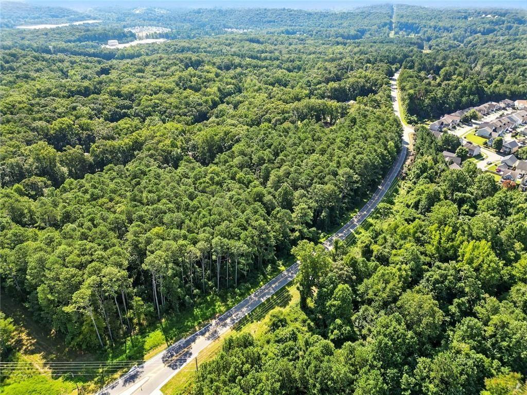 0 Fate Conn Road Canton, GA 30114 - Photo 11 of 12 a view of a lush green field with lots of bushes