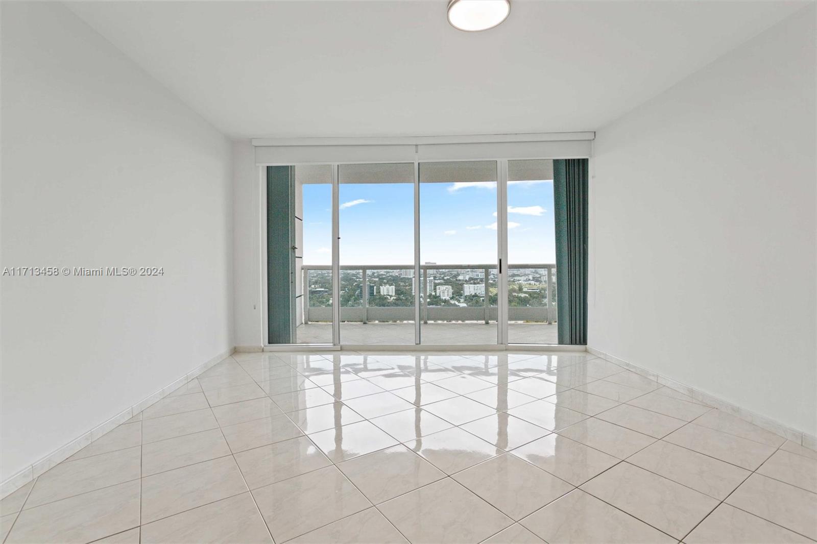 2127 Brickell Avenue, Unit 2804 Miami, FL 33129 - Photo 19 of 72 an empty room with sliding glass door and glass door