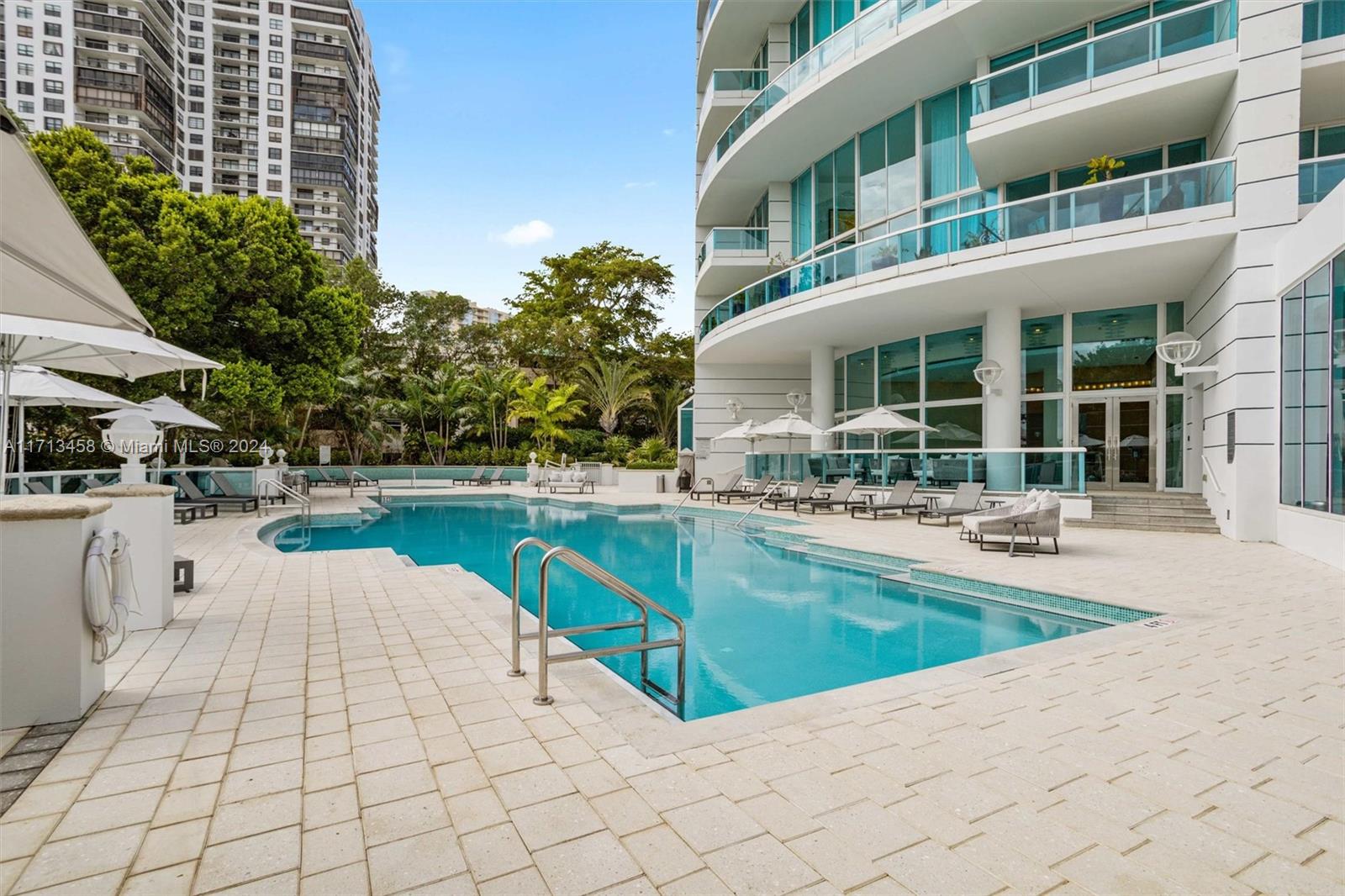 2127 Brickell Avenue, Unit 2804 Miami, FL 33129 - Photo 46 of 72 a swimming pool with outdoor seating and yard
