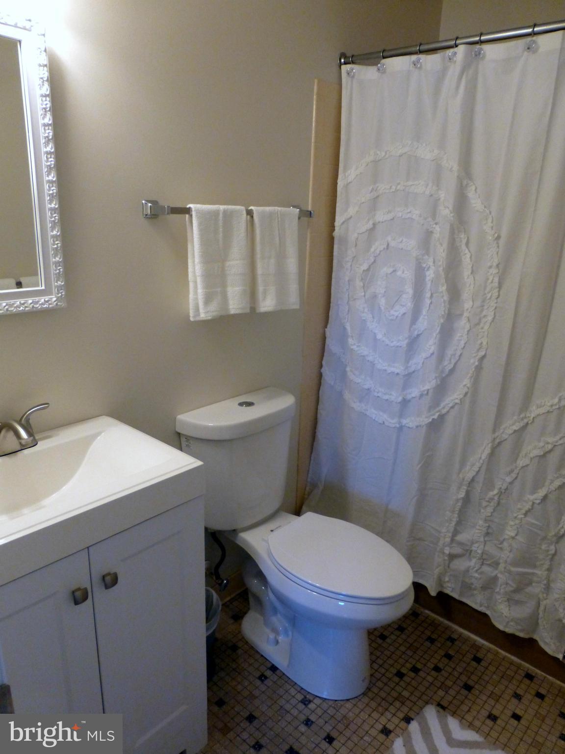 1816 Potomac Road Edgewater, MD 21037 - Photo 14 of 30 a white toilet sitting next to a bathroom sink