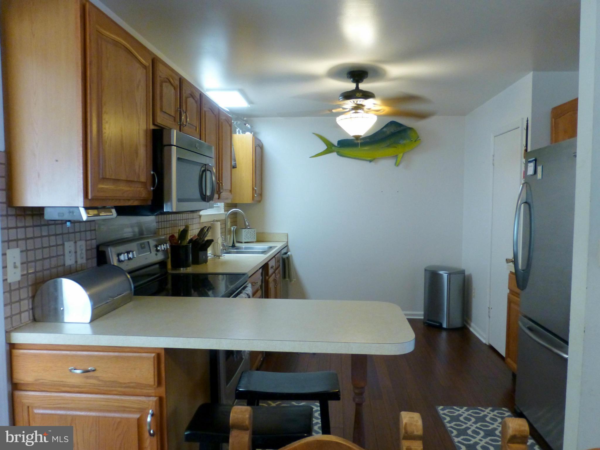 1816 Potomac Road Edgewater, MD 21037 - Photo 8 of 30 a kitchen with a table chairs and a refrigerator