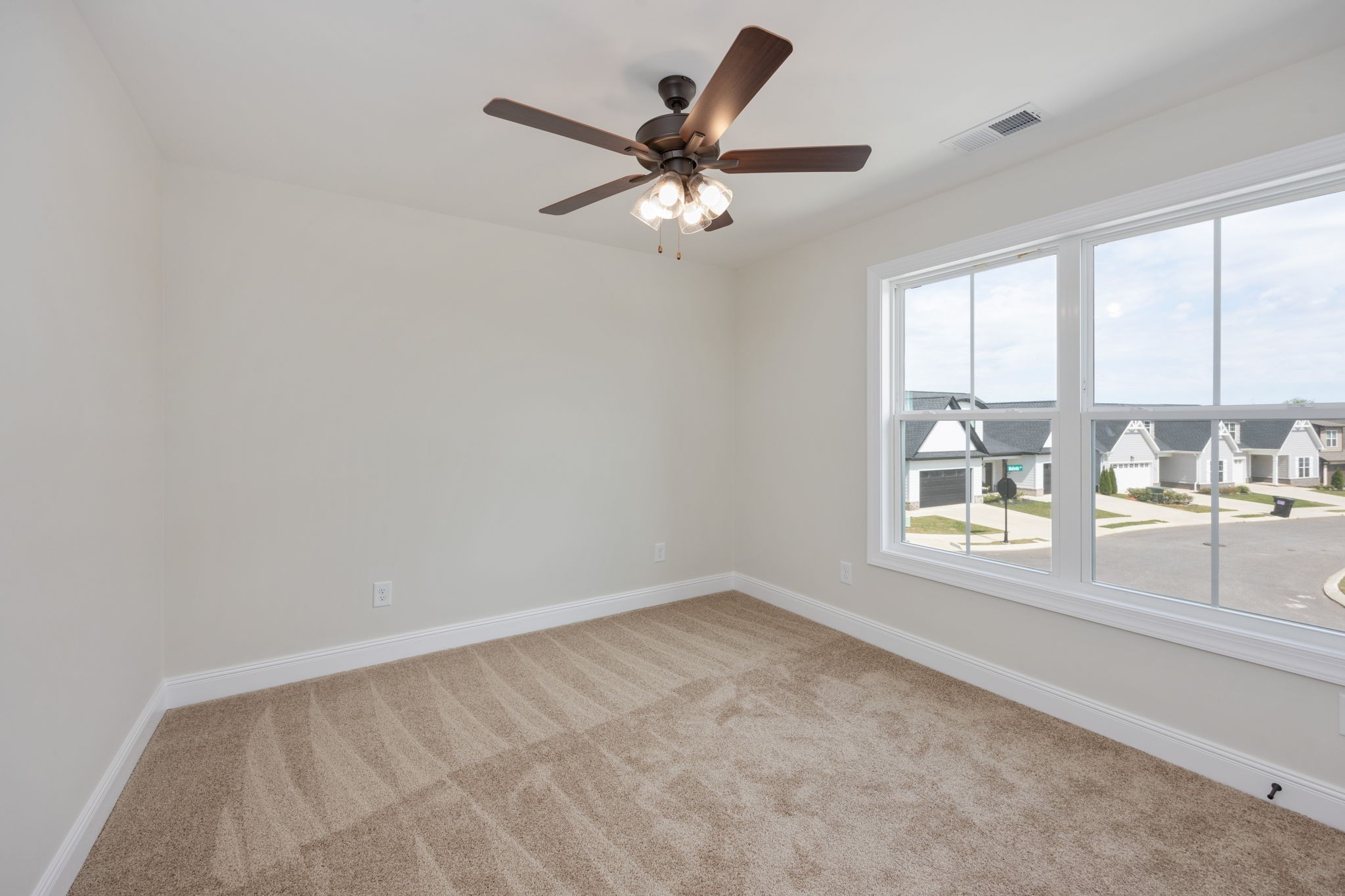 2009 Rylee Way, Unit 22 Greenbrier, TN 37073 - Photo 23 of 28 an empty room with a window and a ceiling fan
