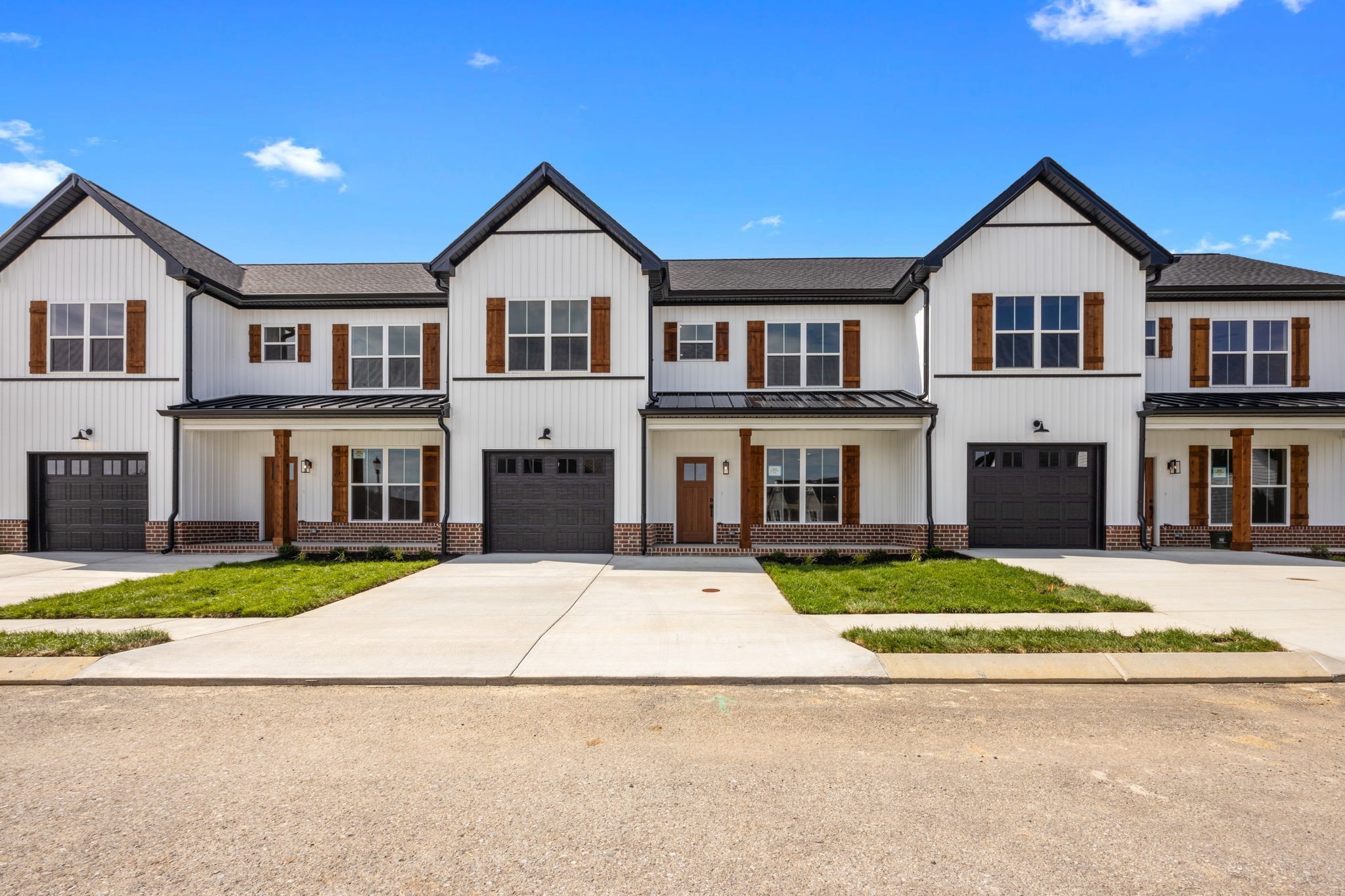 2009 Rylee Way, Unit 22 Greenbrier, TN 37073 - Photo 3 of 28 a front view of a house with a yard and garage