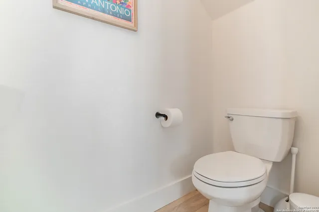a white toilet sitting next to a shower
