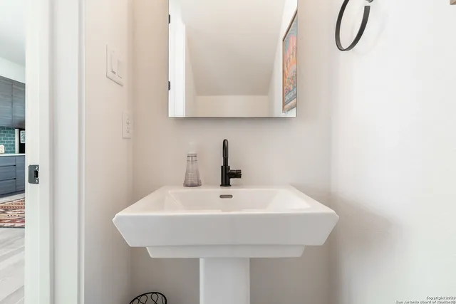 a bathroom with a sink and mirror