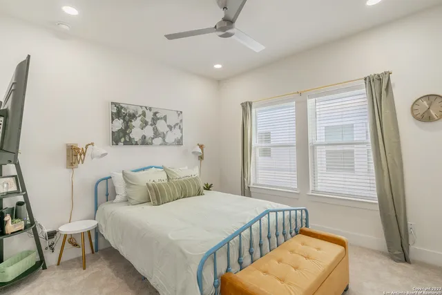 a bedroom with a bed and a television