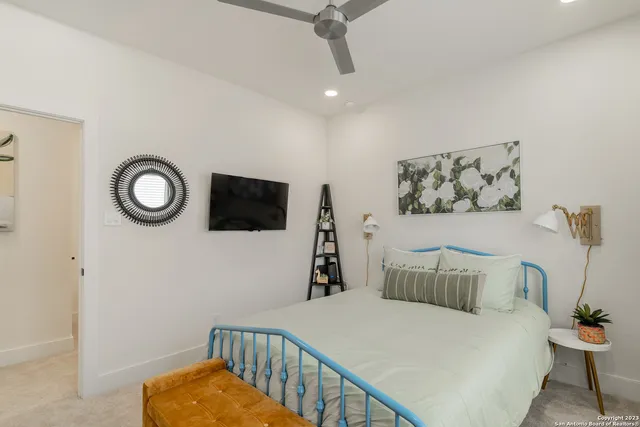 a bedroom with a bed and a flat screen tv