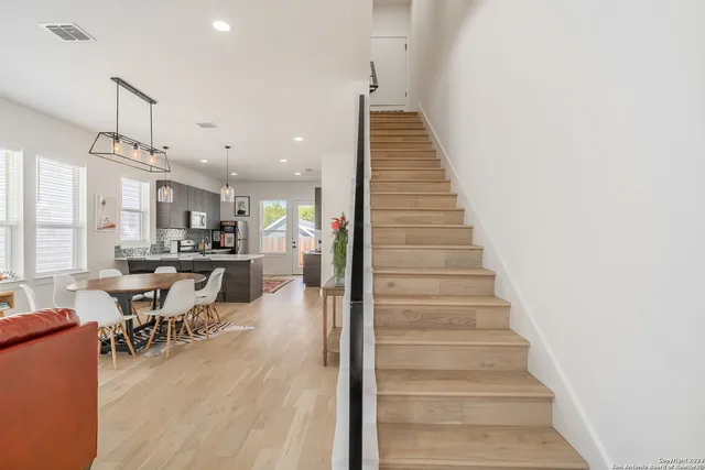 a dining room with furniture and wooden floor