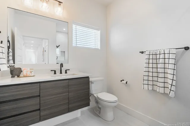 a bathroom with a double vanity sink and a mirror