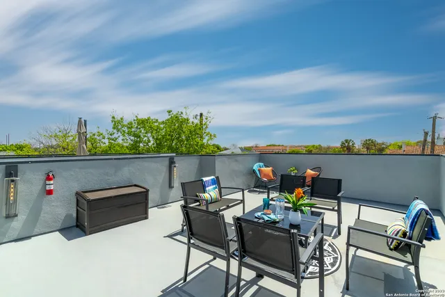 a view of a chairs and table in patio