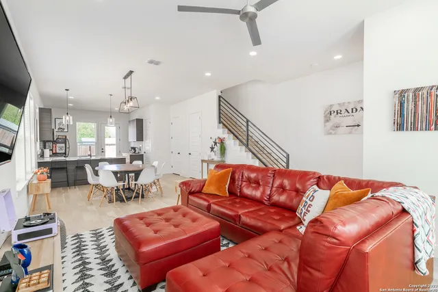 a living room with furniture a rug and a chandelier