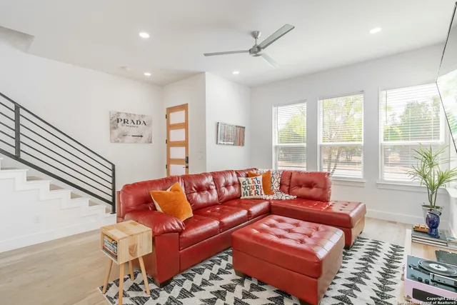 a living room with furniture and a large window