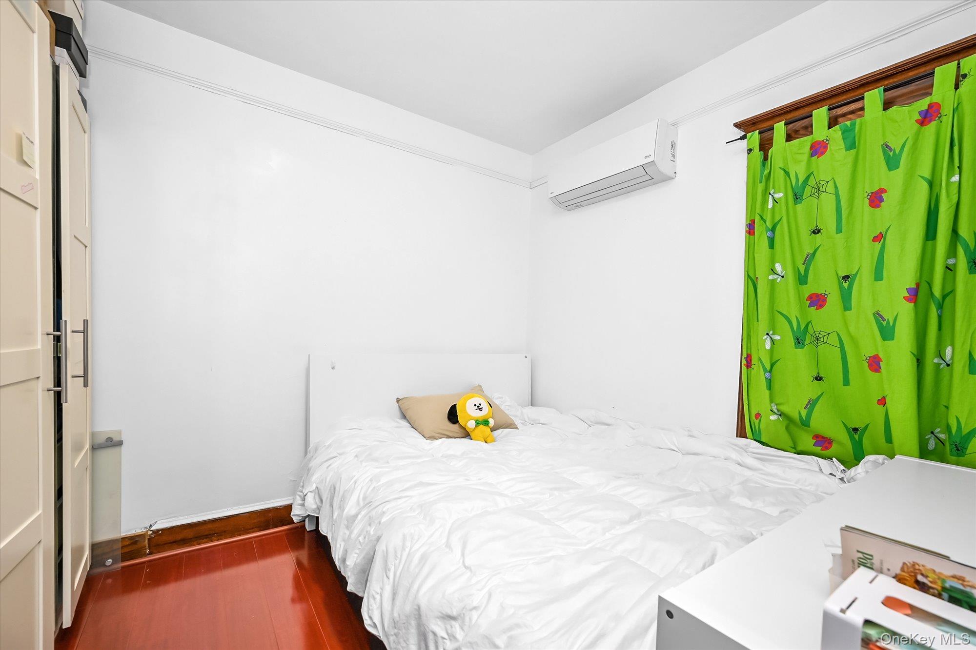 87-71 111th Street Queens, NY 11418 - Photo 12 of 17 a bedroom with a bed and a window