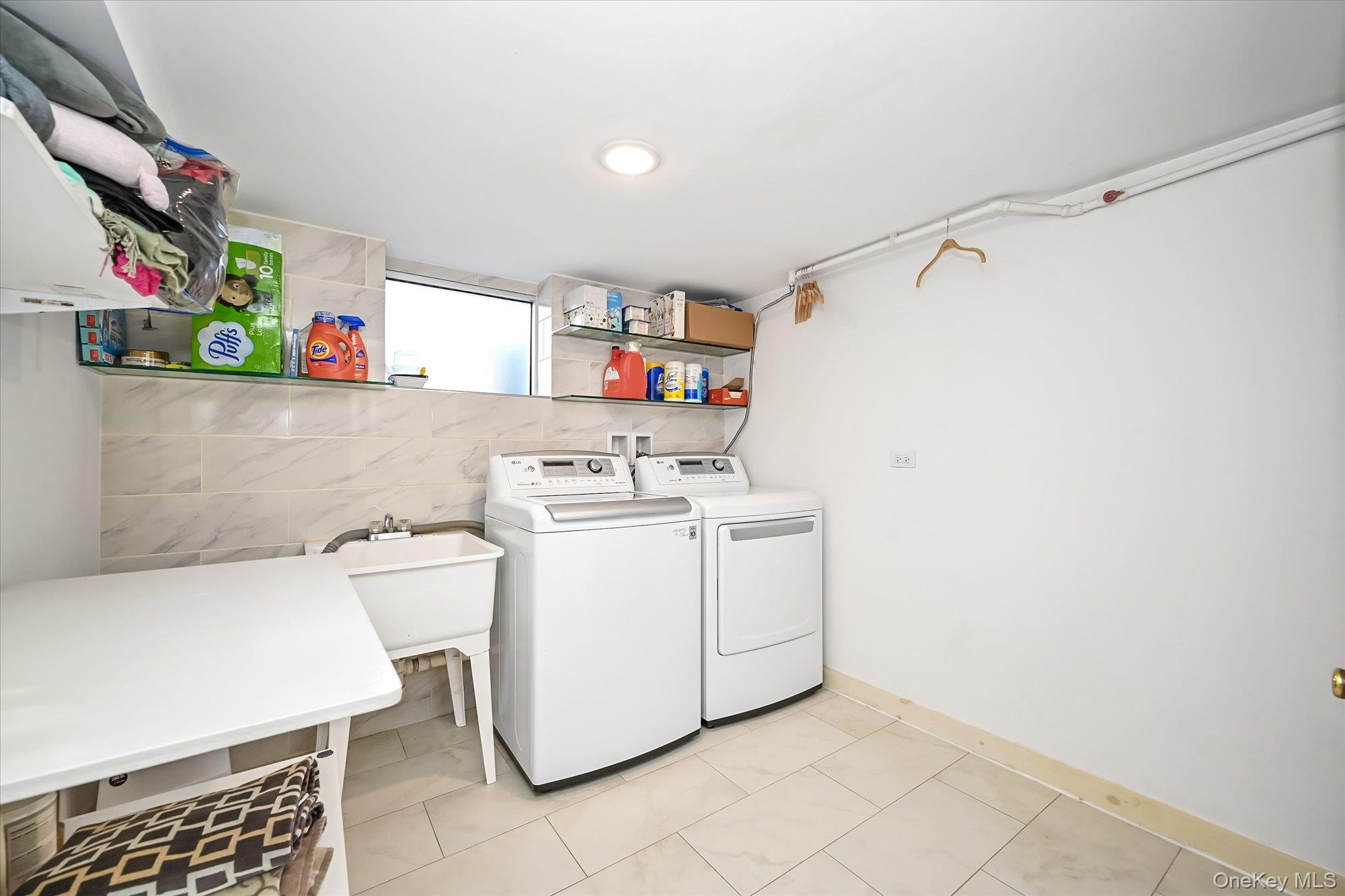 87-71 111th Street Queens, NY 11418 - Photo 15 of 17 a utility room with dryer and washer