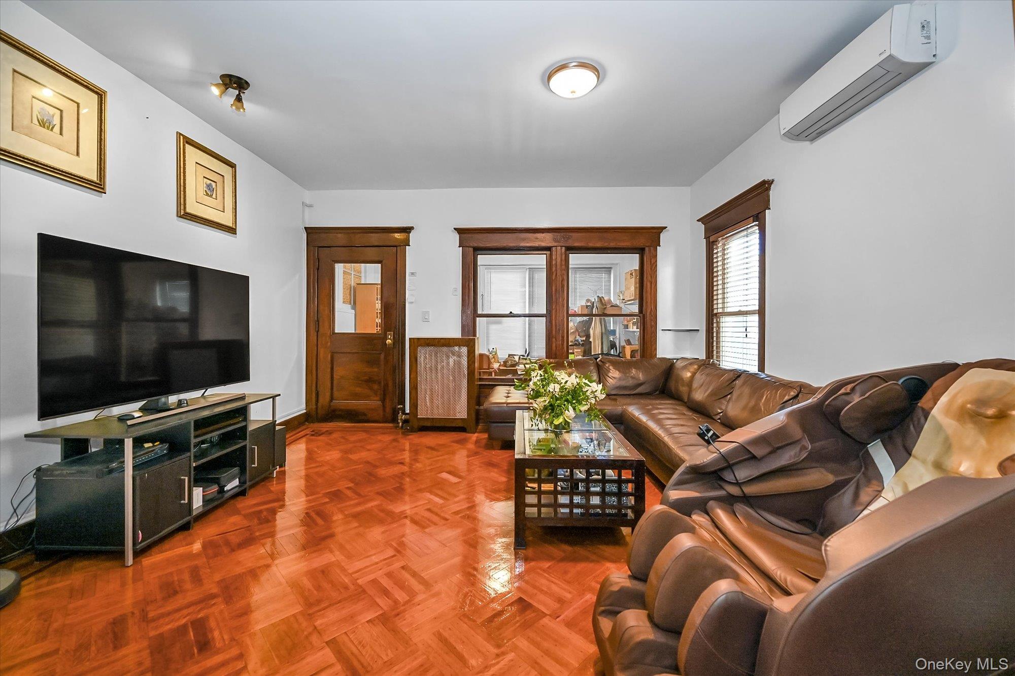 87-71 111th Street Queens, NY 11418 - Photo 2 of 17 a living room with furniture and a flat screen tv