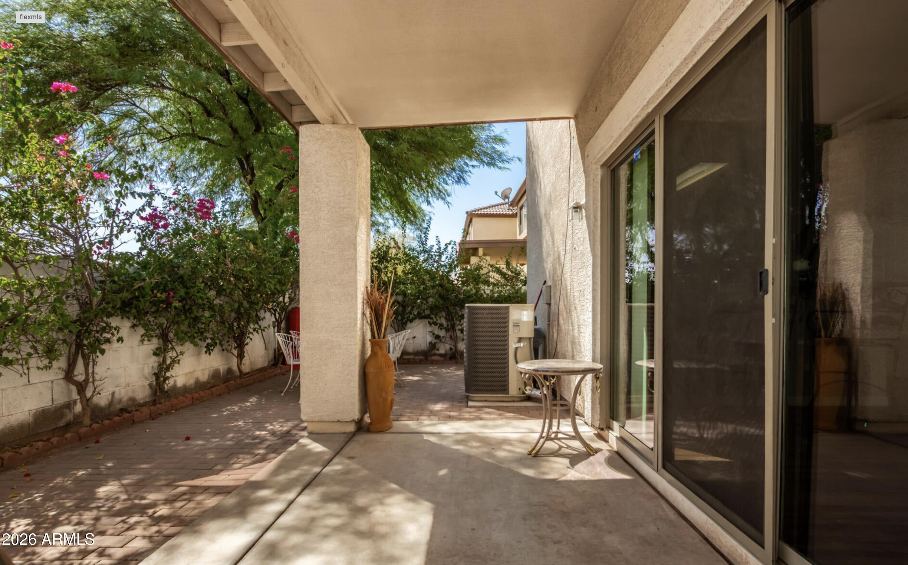 10225 West Camelback Road, Unit 12 Phoenix, AZ 85037 - Photo 16 of 19 a view of porch with two chairs and a potted plant