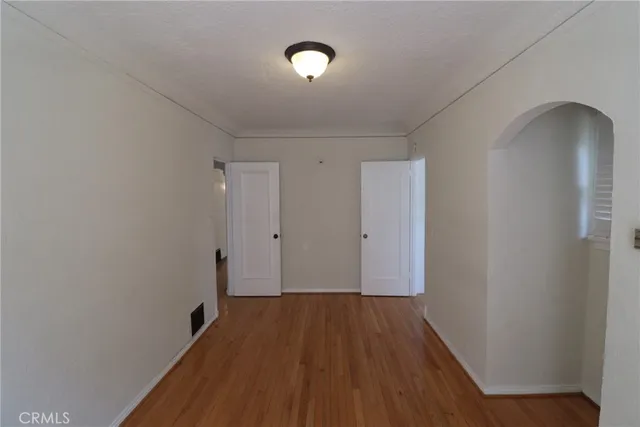 a view of a room with wooden floor