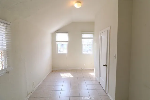 an empty room with windows and entrance