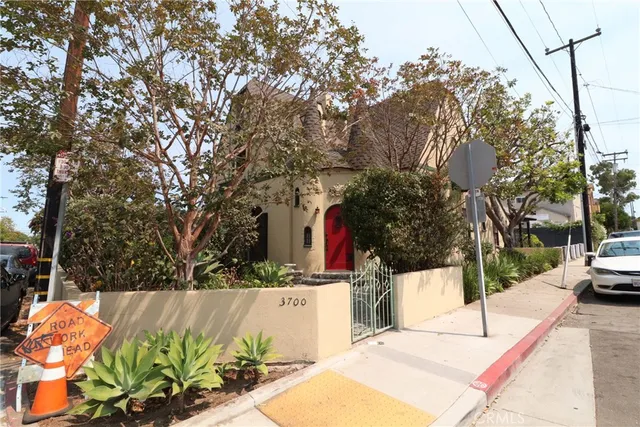 a view of a white house with a yard