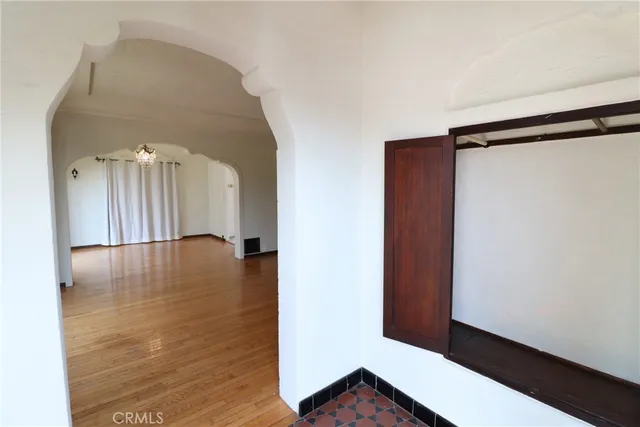 a view of a hallway with wooden floor