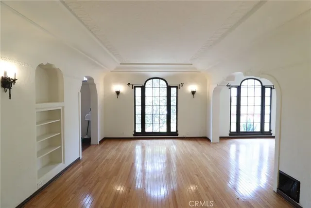 a view of a room with wooden floors and entryway