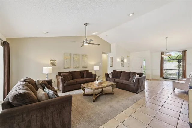 a living room with furniture and a chandelier