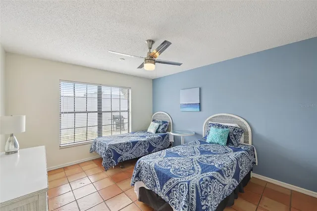 a bedroom with two beds and a window