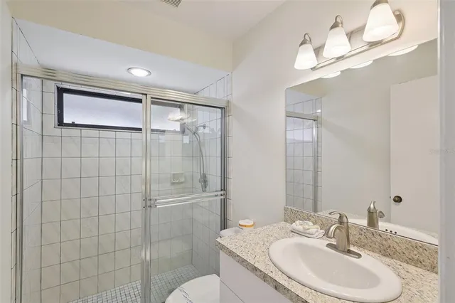 a bathroom with a sink toilet and shower