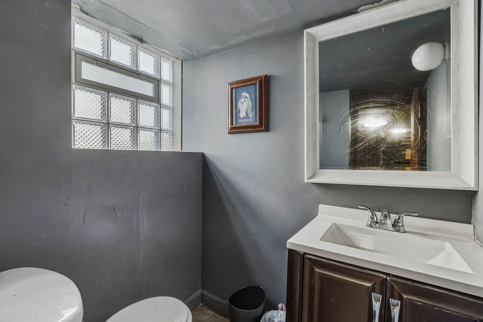 7127 South St Lawrence Avenue Chicago, IL 60619 - Photo 18 of 26 a bathroom with a toilet sink and mirror