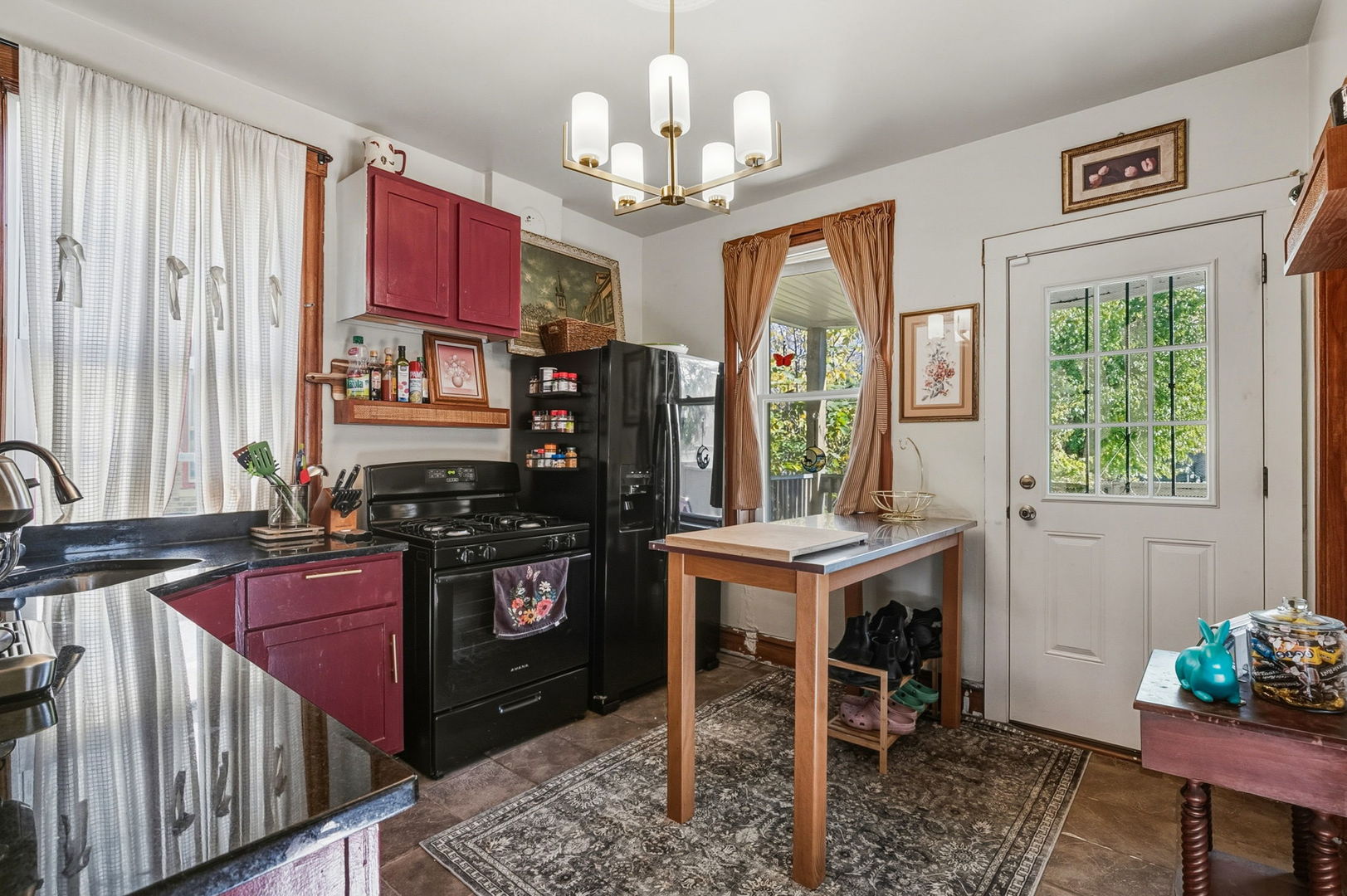 7127 South St Lawrence Avenue Chicago, IL 60619 - Photo 6 of 26 a kitchen with stainless steel appliances granite countertop a stove top oven a sink dishwasher and a dining table with wooden floor