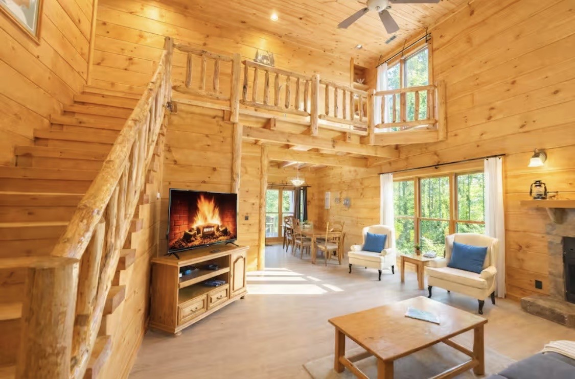 a living room with furniture a fireplace and a flat screen tv