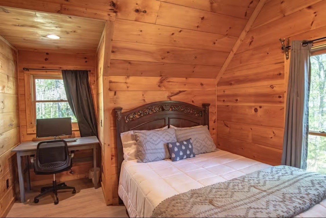 298 Eagle Lake Road Coalmont, TN 37313 - Photo 16 of 38 a bedroom with a bed a desk and chair with windows