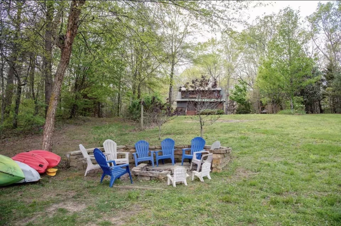 298 Eagle Lake Road Coalmont, TN 37313 - Photo 27 of 38 a view of a lake with chairs and table