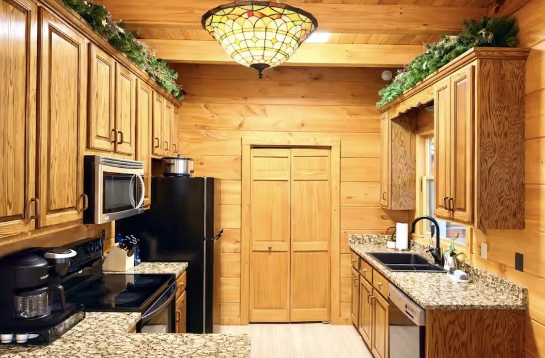 298 Eagle Lake Road Coalmont, TN 37313 - Photo 6 of 38 a kitchen with stainless steel appliances granite countertop a refrigerator a stove and a microwave
