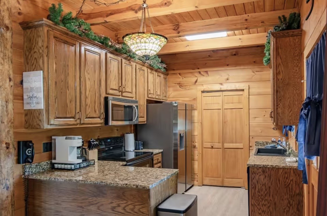 298 Eagle Lake Road Coalmont, TN 37313 - Photo 8 of 38 a kitchen with stainless steel appliances granite countertop a refrigerator a stove and a sink with cabinets