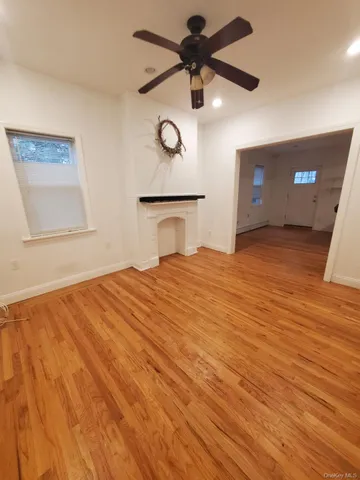 a bedroom with a bed and a ceiling fan